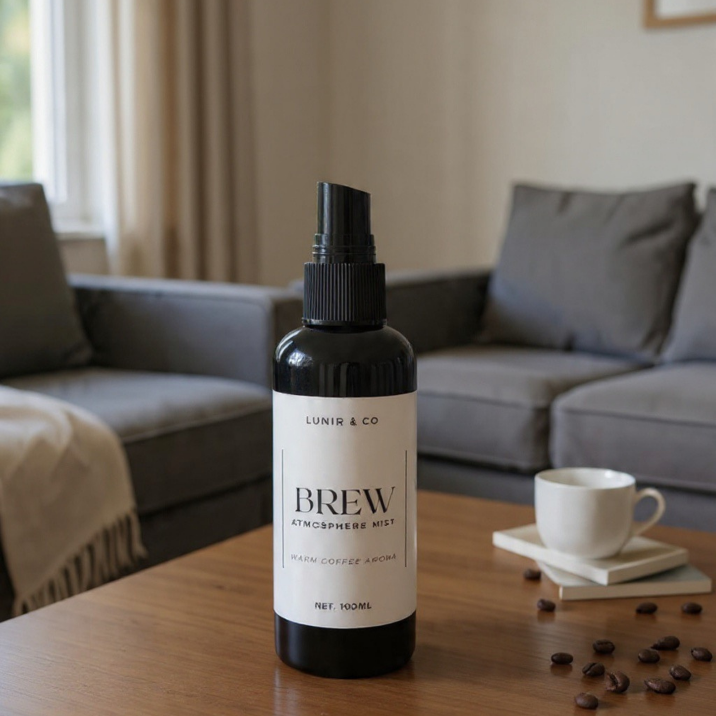 Bottle of 'Brew' atmosphere mist on a wooden table with a cup and coffee beans in a living room setting.