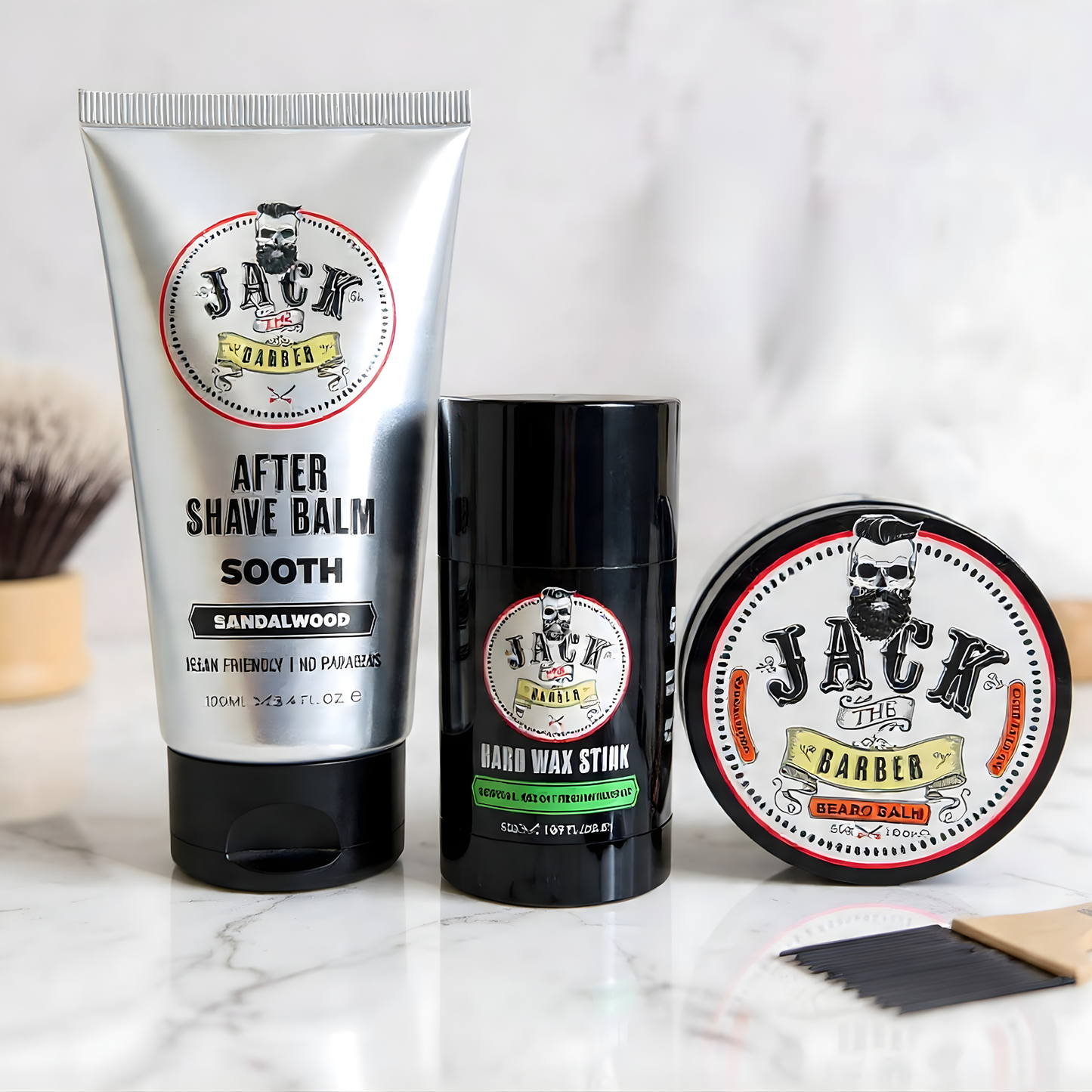 Three grooming products from Jack the Barber on a marble surface with a blurred background.