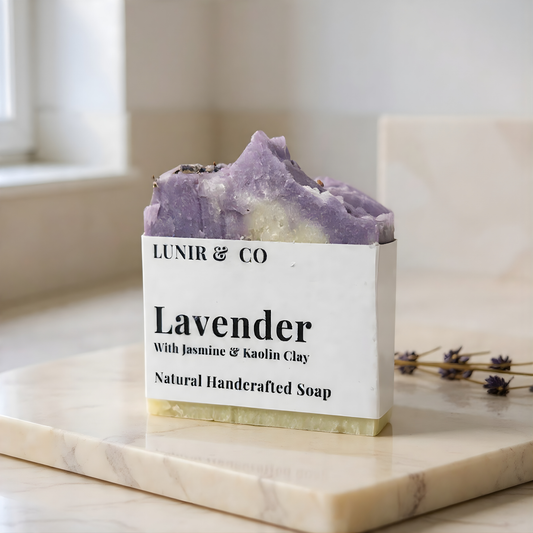 Lavender soap bar with packaging labeled 'LUNIR & CO' on a marble surface.