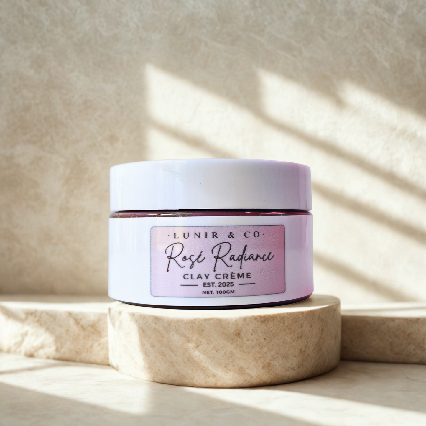 Jar of 'Rosé Radiance Clay Crème' by Lunir & Co on a neutral background