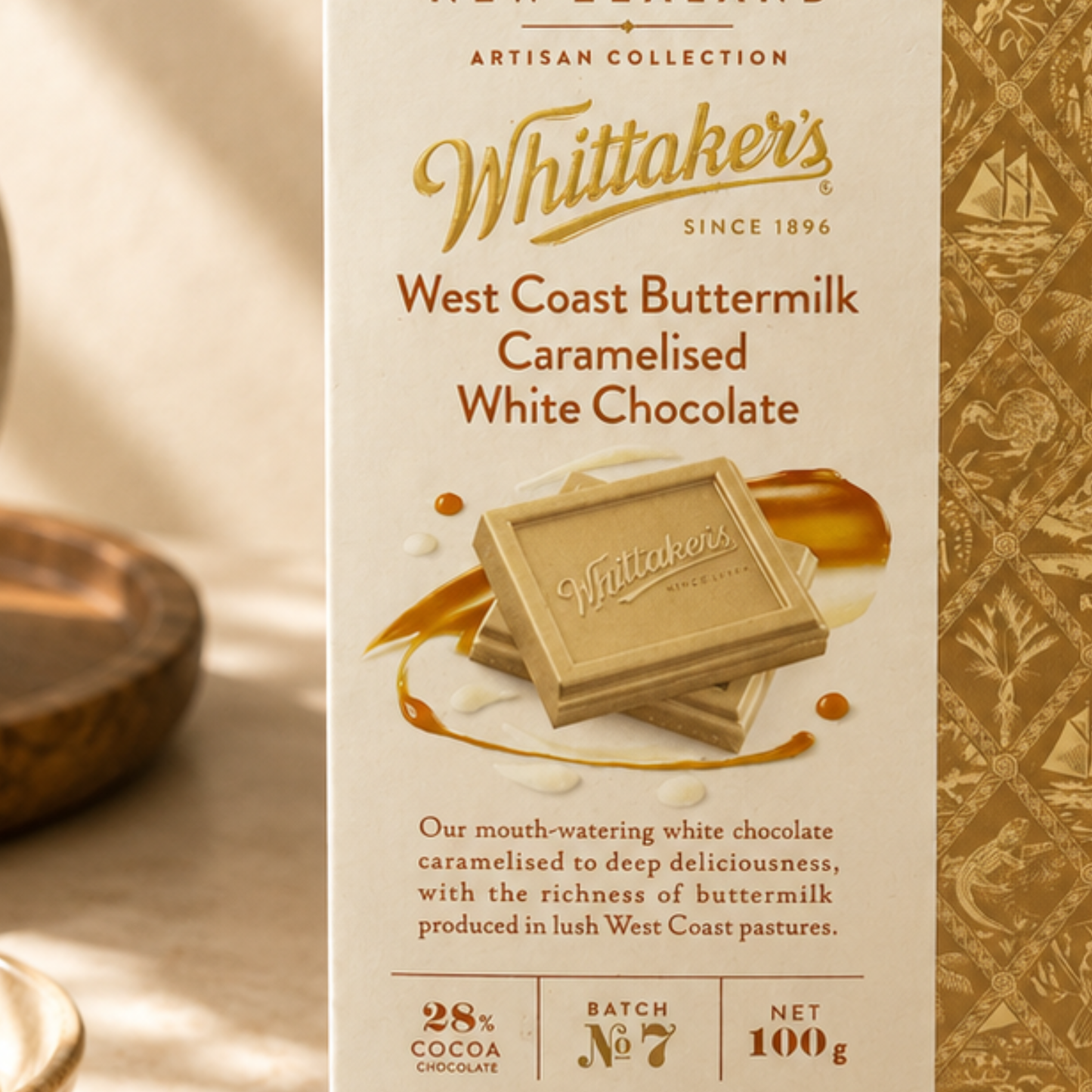 Whittaker's West Coast Buttermilk Caramelised White Chocolate packaging on a beige background