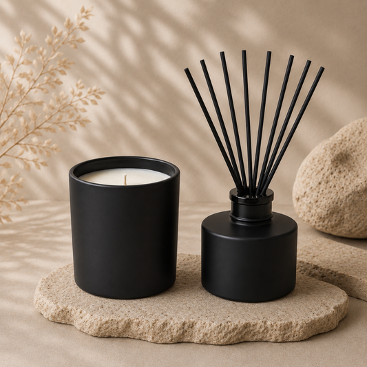 Black candle and diffuser on a stone surface with a neutral background