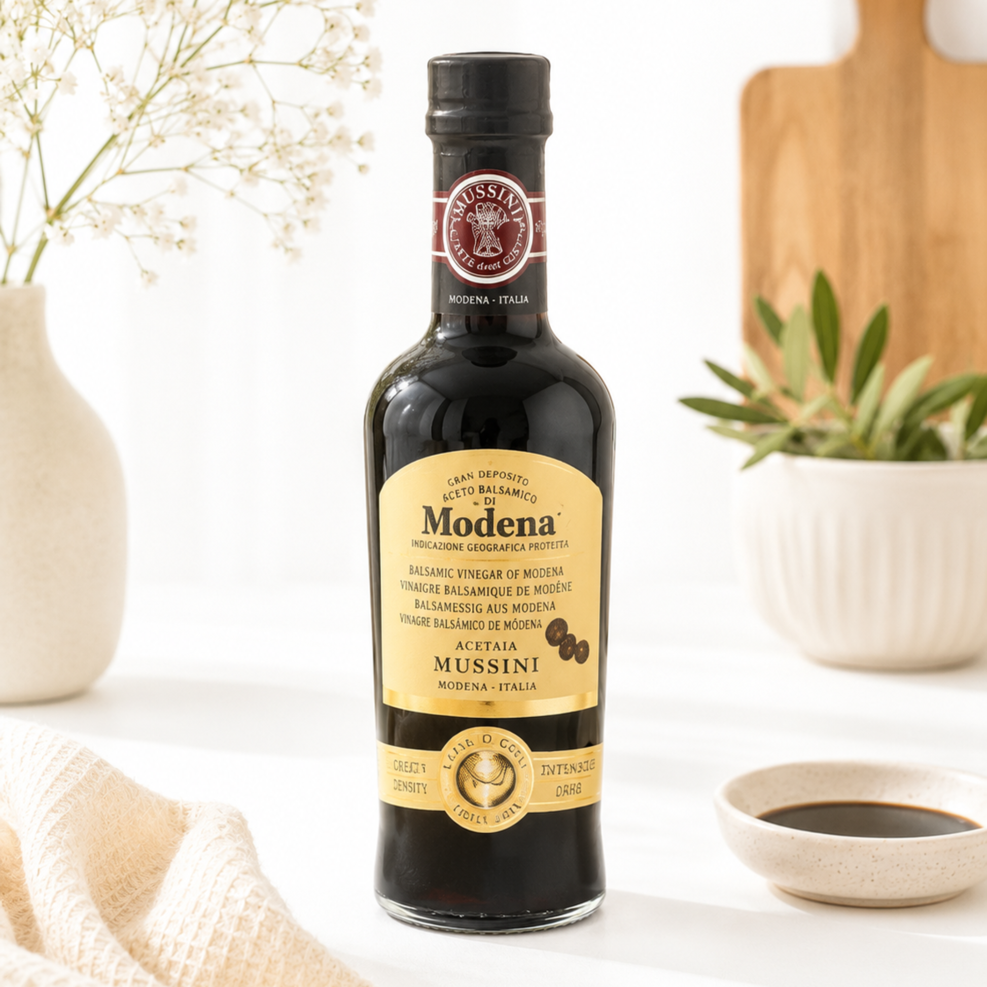 Bottle of Modena balsamic vinegar on a table with decorative elements
