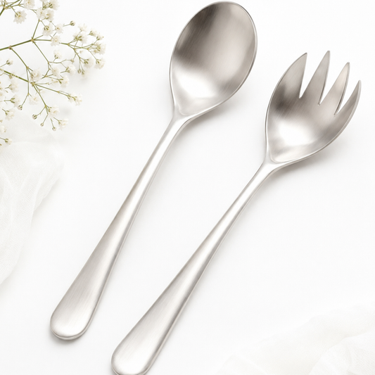 Stainless steel spoon and fork set on a white background with small flowers.