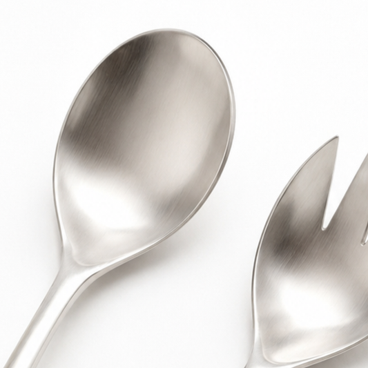 Metallic spoon and fork on a white background