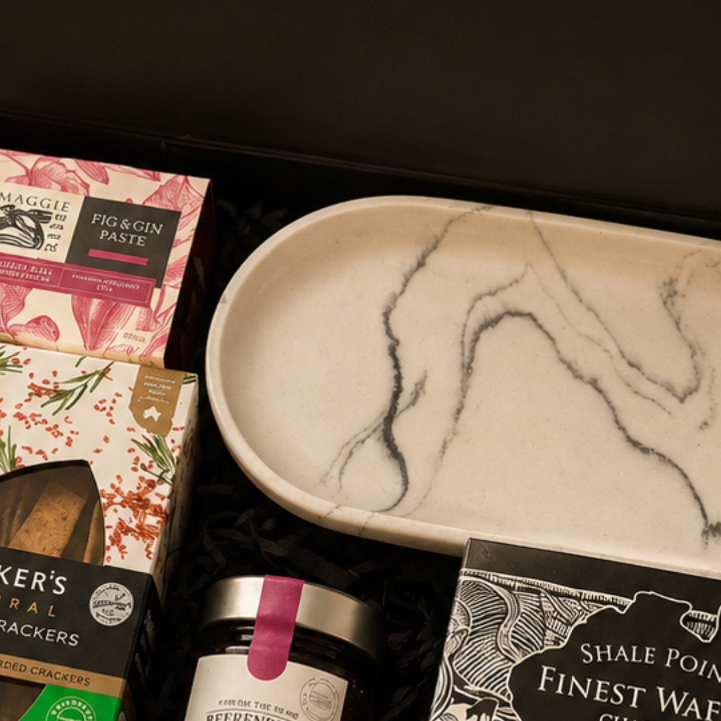 Gourmet gift set with crackers, paste, and a marble-patterned plate.