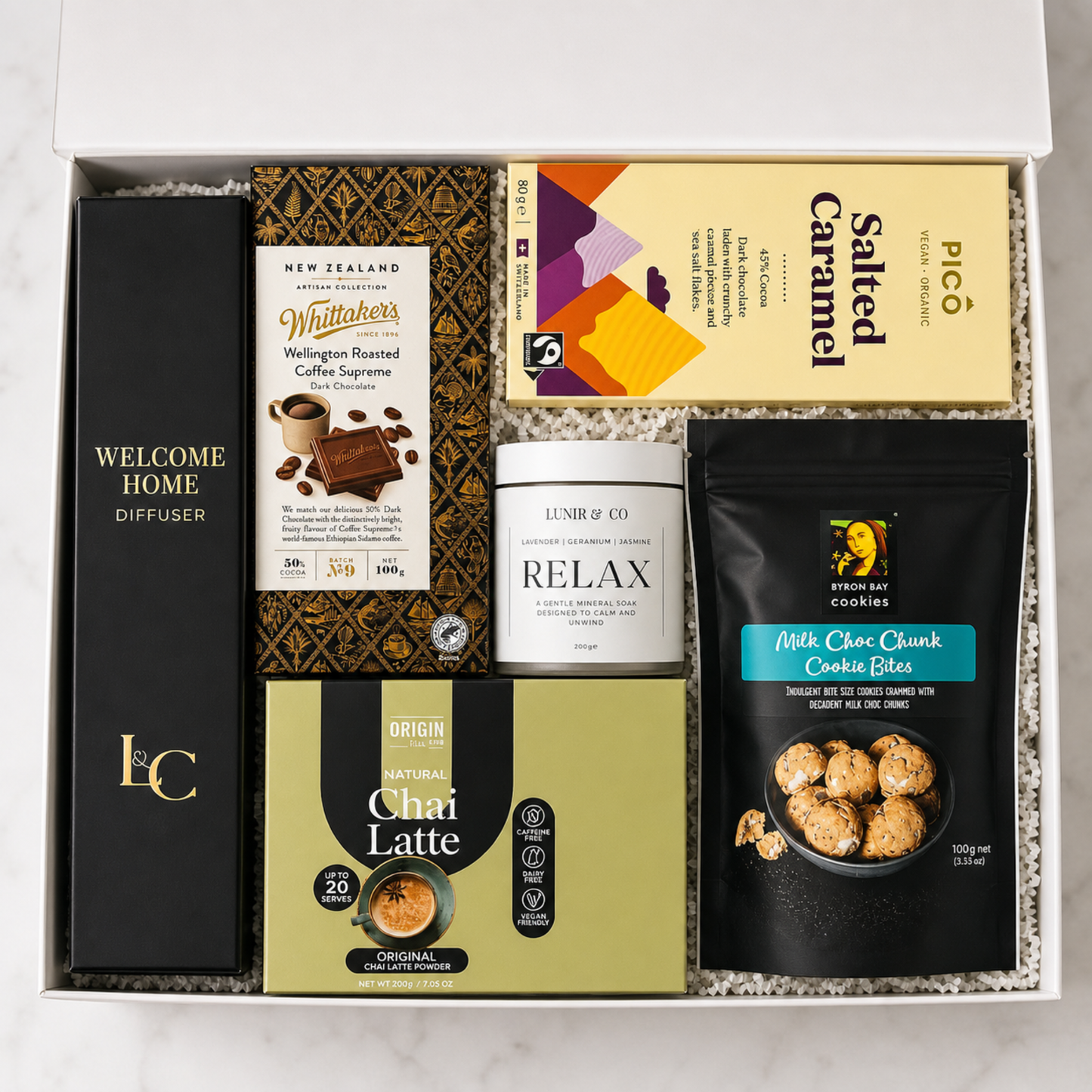 Gift set with coffee products, a diffuser, and cookies in a box.