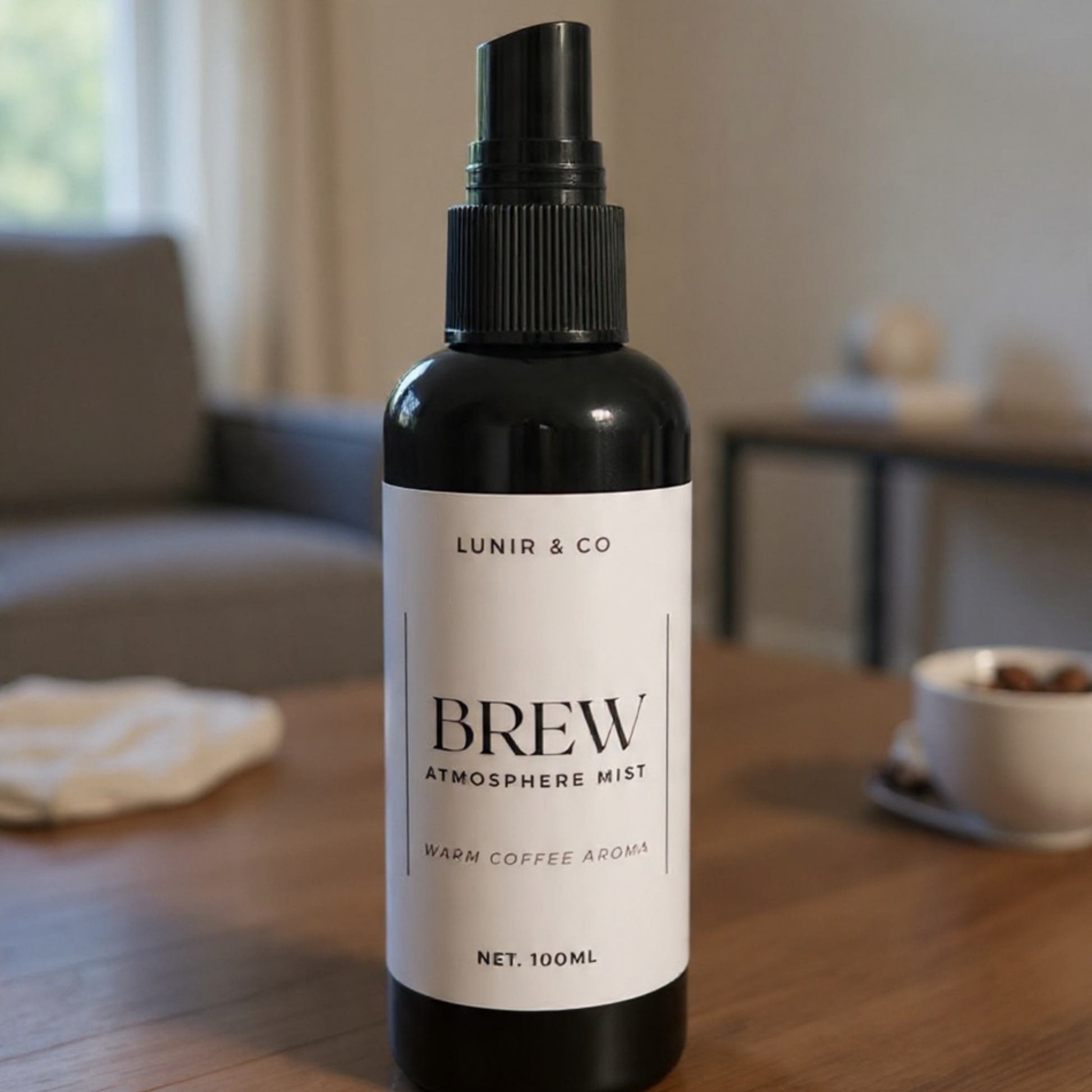 Bottle of 'Brew' atmosphere mist by Lunir & Co on a wooden table with a blurred background