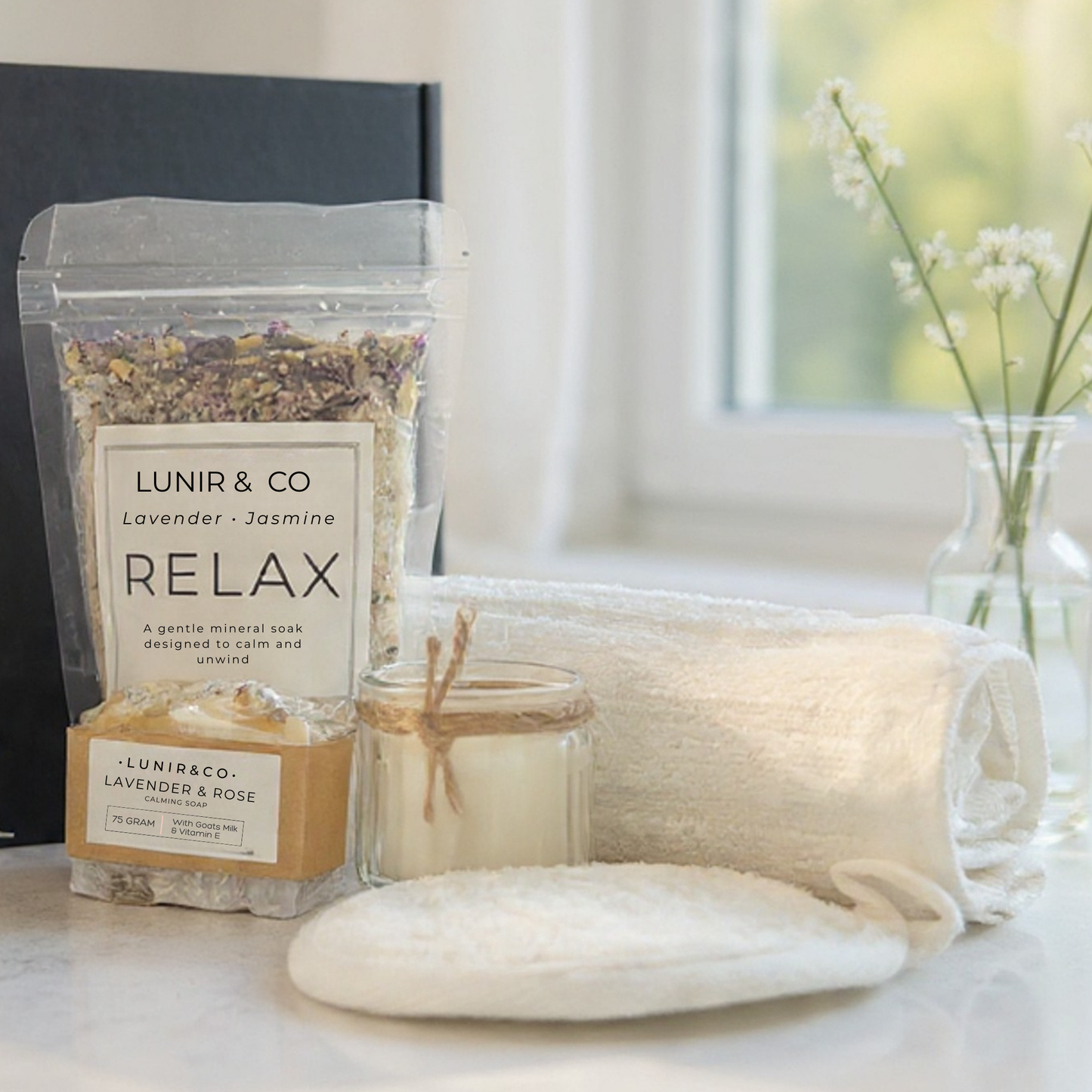 Relaxation products including a bag of LUNIR & CO lavender and jasmine relax, a candle, and soap on a table.