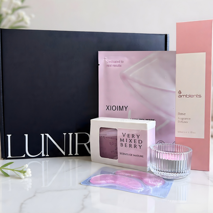 Cosmetic products including a black box, pink packaging, and eye masks on a white surface.