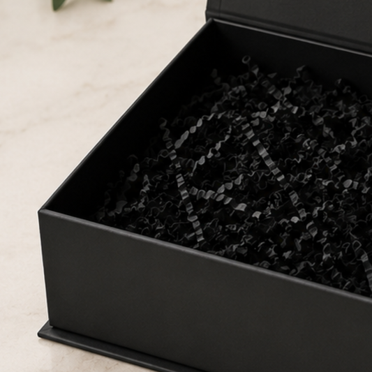 Black box with crinkled black paper lining on a light background