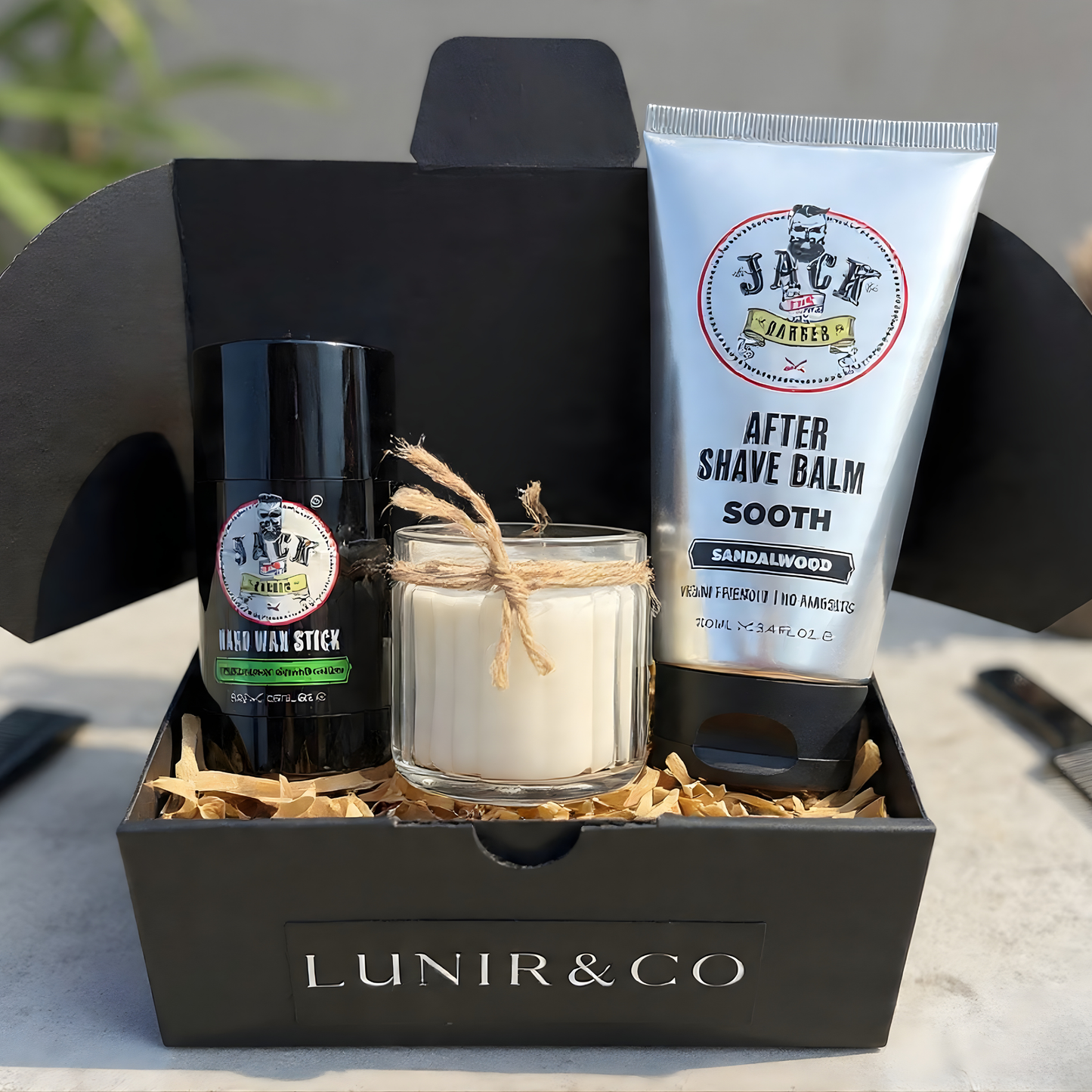 Barber & Co forming cream, Lunir & Co black ash soap, and a scrubber on a marble surface.