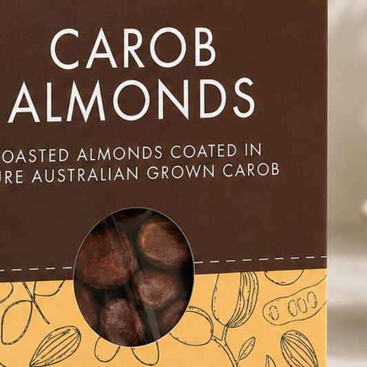 Packaging of carob almonds with a brown and yellow design.