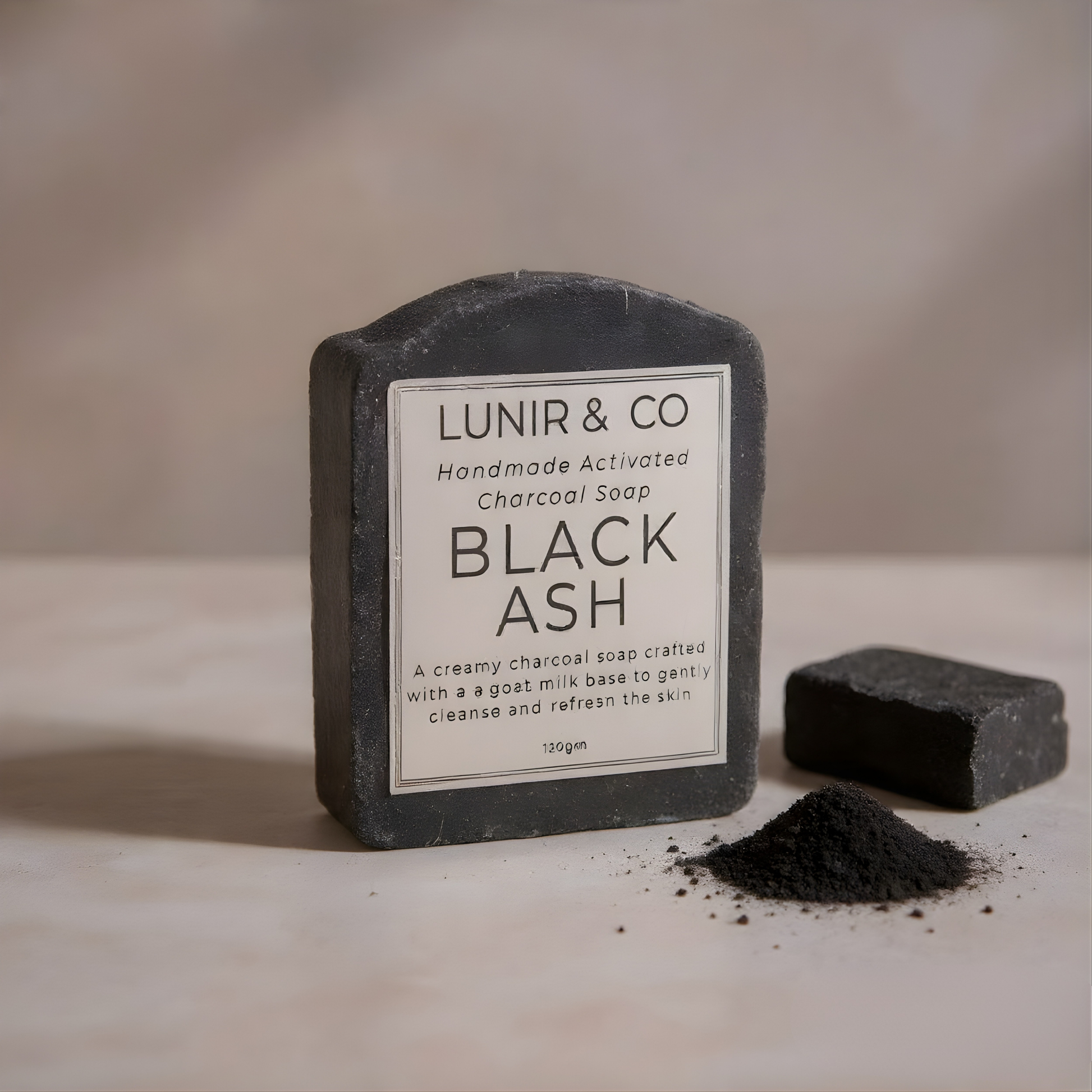 Black activated charcoal soap bar with 'LUNIR & CO' label on a neutral background