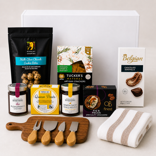 Assorted gourmet food items including cookies, crackers, and spreads on a white surface.