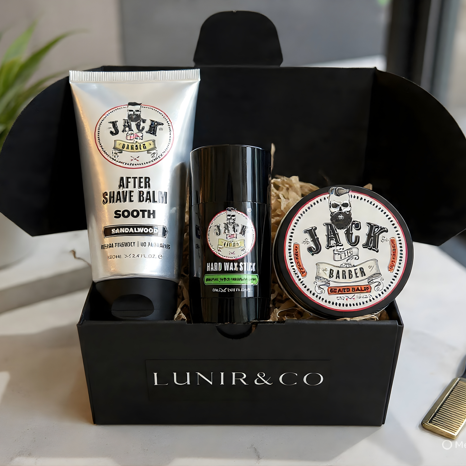 Gift set with bath bombs, soap, and a bottle in a black box on a neutral background