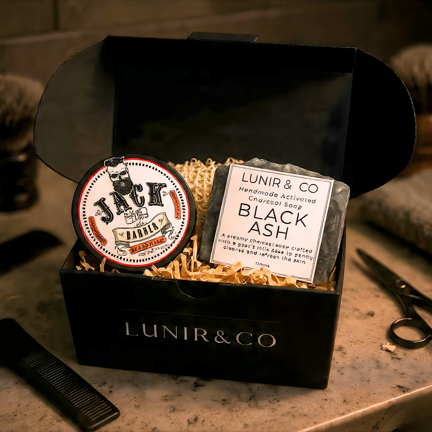 Barber & Co. forming cream, Lunir & Co. black ash soap, and a loofah on a marble surface.
