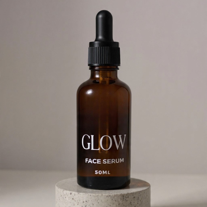 Brown glass bottle of face serum labeled 'GLOW' on a neutral background