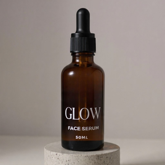 Brown glass bottle of face serum labeled 'GLOW' on a neutral background