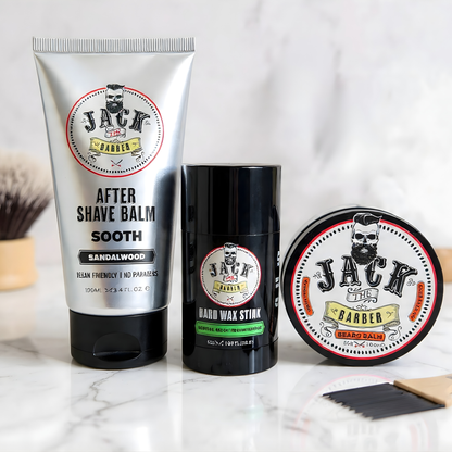 Three grooming products from Jack the Barber on a marble surface with a blurred background.