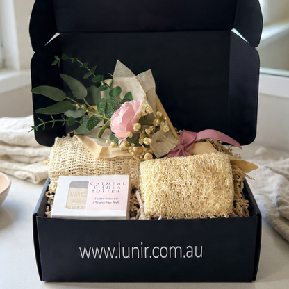 Gift set with natural products and flowers in a black box, featuring the brand 'lunir.com.au'.