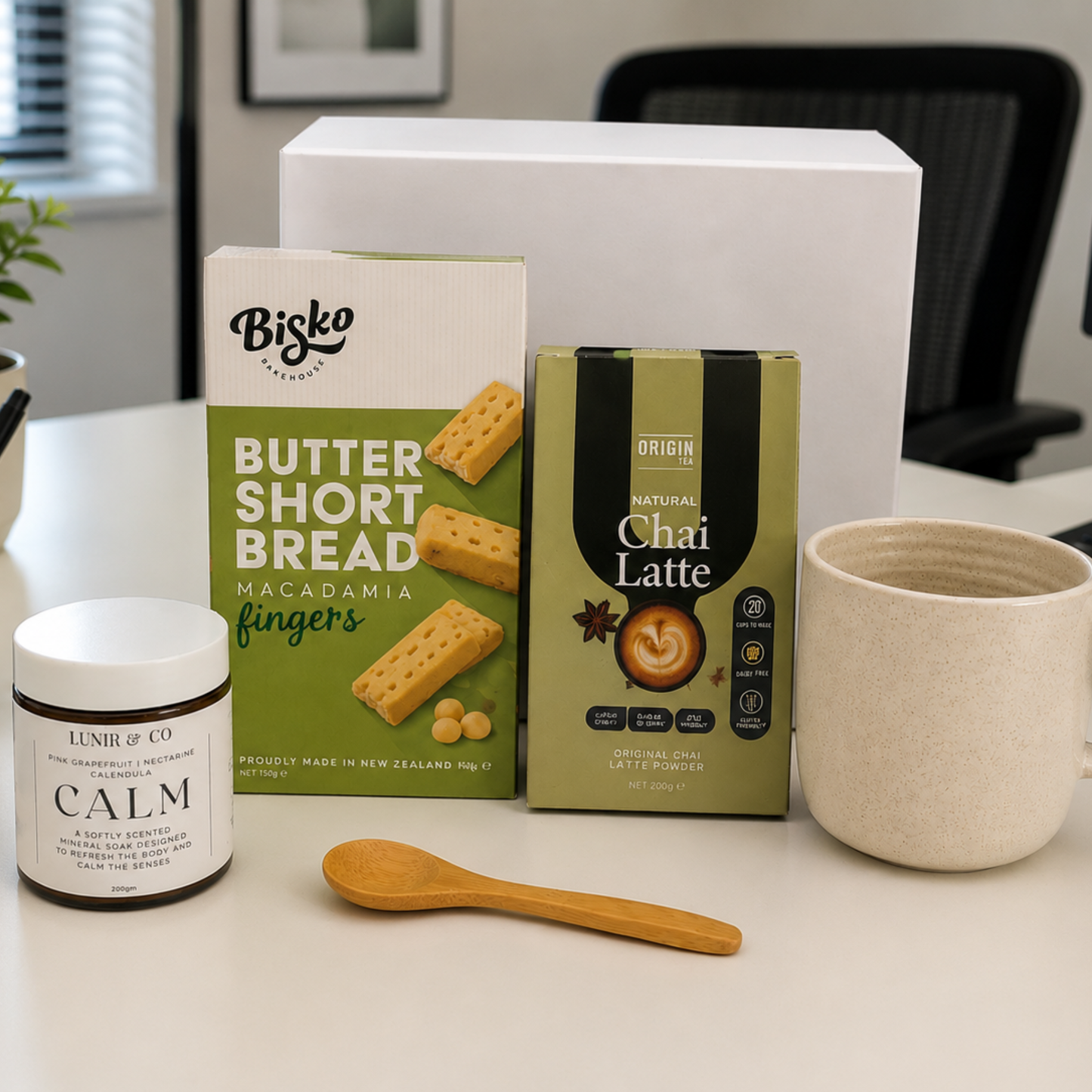 Desk with snacks, a mug, and a jar labeled 'Calm' in an office setting.