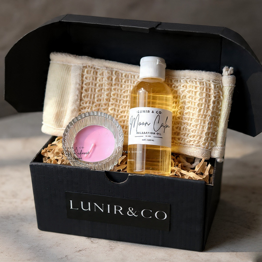 Glowing skincare product set with a candle and face mask in a black box, featuring the brand 'Lunir'.