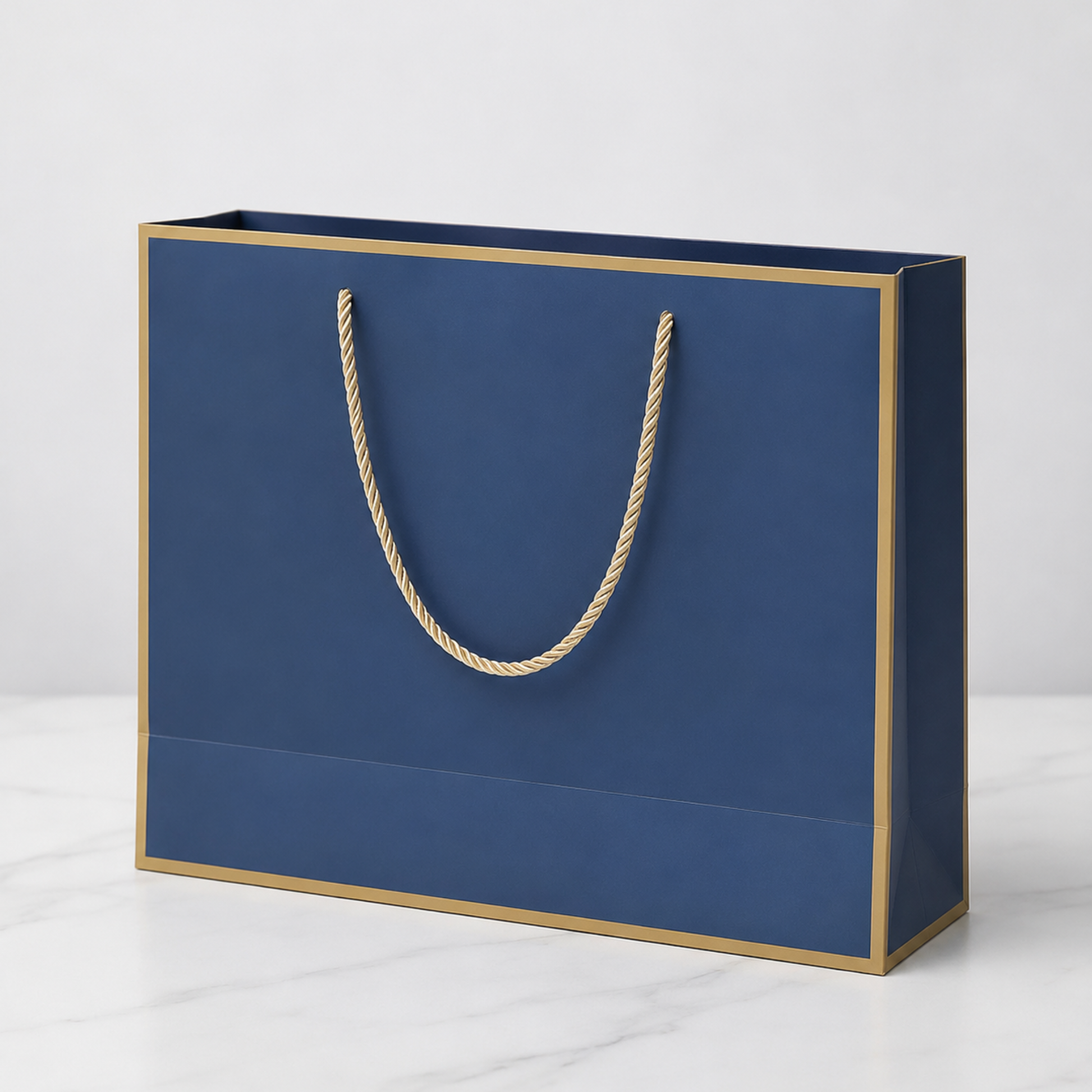 Blue paper bag with gold edges and handle on a white background