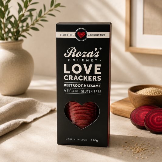 Box of Roza's Gourmet Love Crackers with heart design on a neutral background