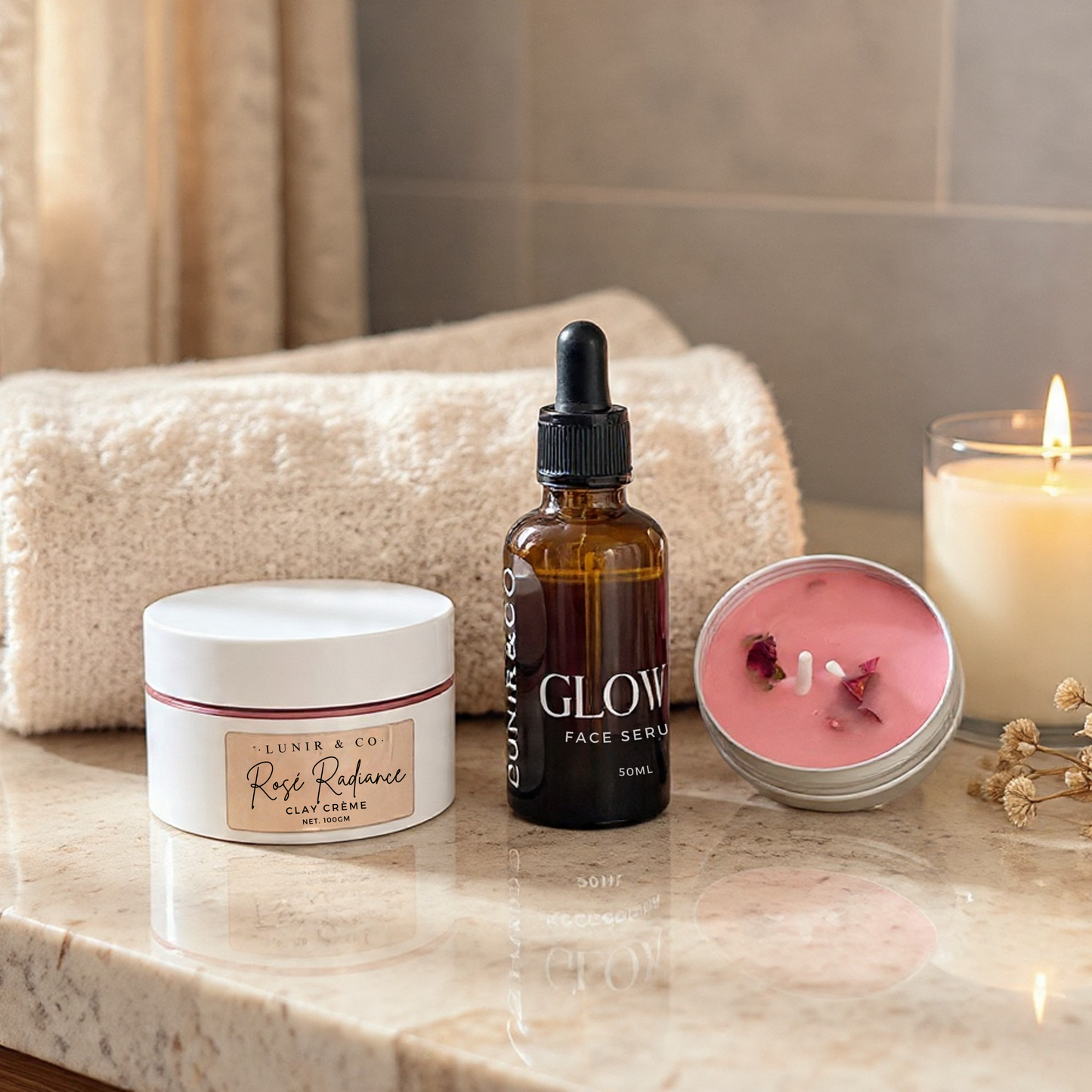 Cosmetic products including a jar, bottle, and candle on a marble surface with a towel in the background.