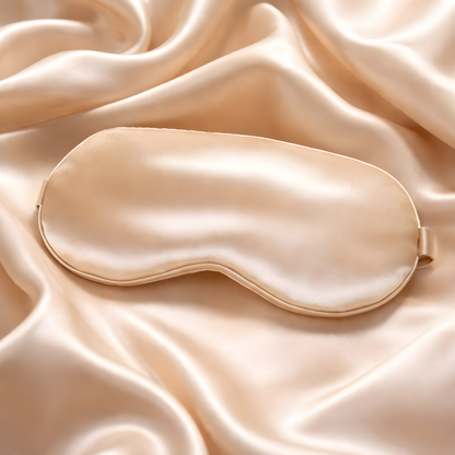 Beige satin sleep mask on a matching fabric background