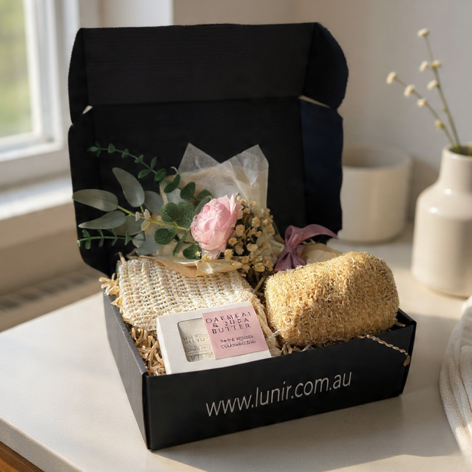 Gift box with bath products and flowers on a table