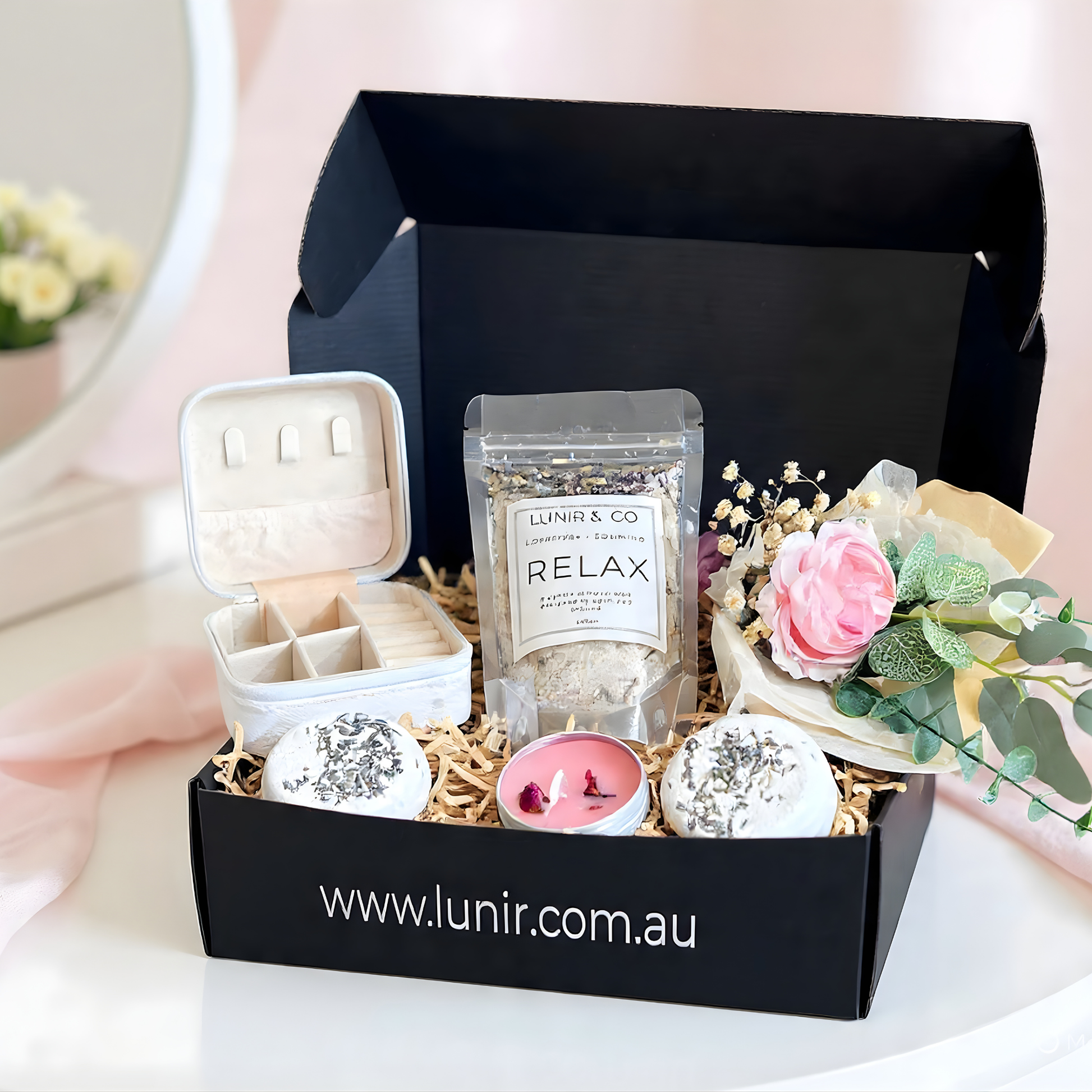 Collagen gel mask packaging with pink scrunchie and other items on a white surface