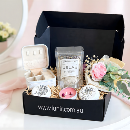 Collagen gel mask packaging with pink scrunchie and other items on a white surface