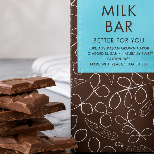 Milk chocolate bars with a 'Milk Bar' carob bar packaging on a light background