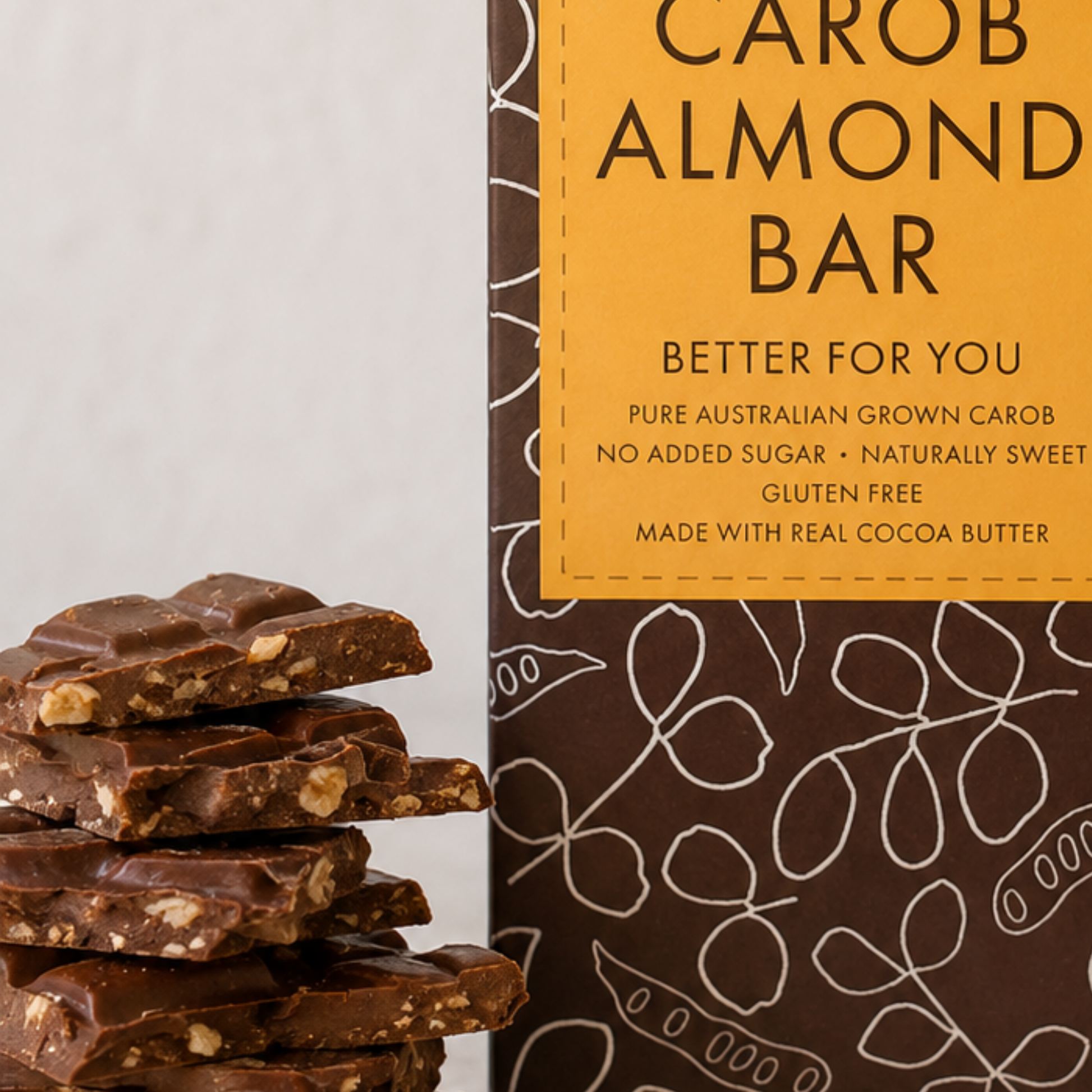 Carob almond bar packaging with a stack of bars on a light gray background