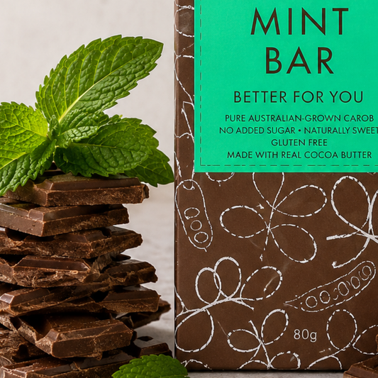Chocolate bar with mint leaves and a packaging label on a light background