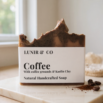 Bar of coffee soap with visible branding on a marble surface