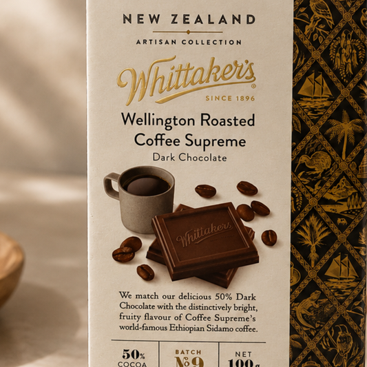 Whittaker's Wellington Roasted Coffee Supreme Dark Chocolate packaging with coffee cup and beans on a beige background.