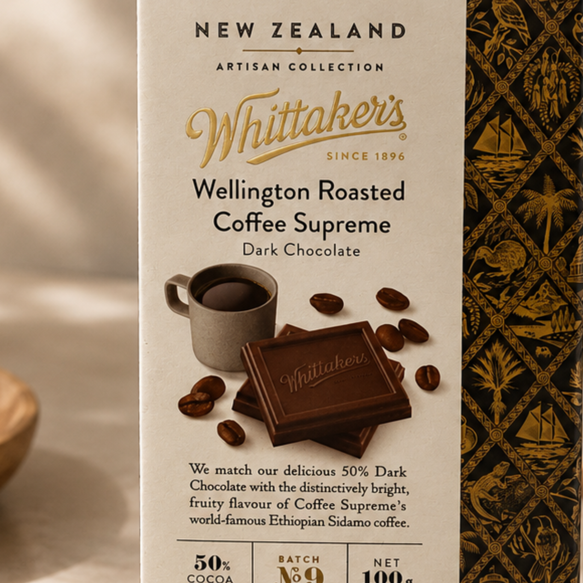 Whittaker's Wellington Roasted Coffee Supreme Dark Chocolate packaging with coffee cup and beans on a beige background.