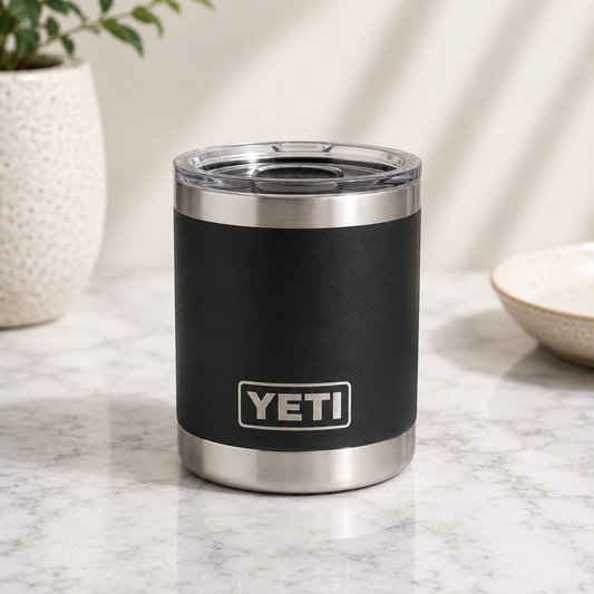 Black YETI tumbler on a marble surface with a plant and bowl in the background
