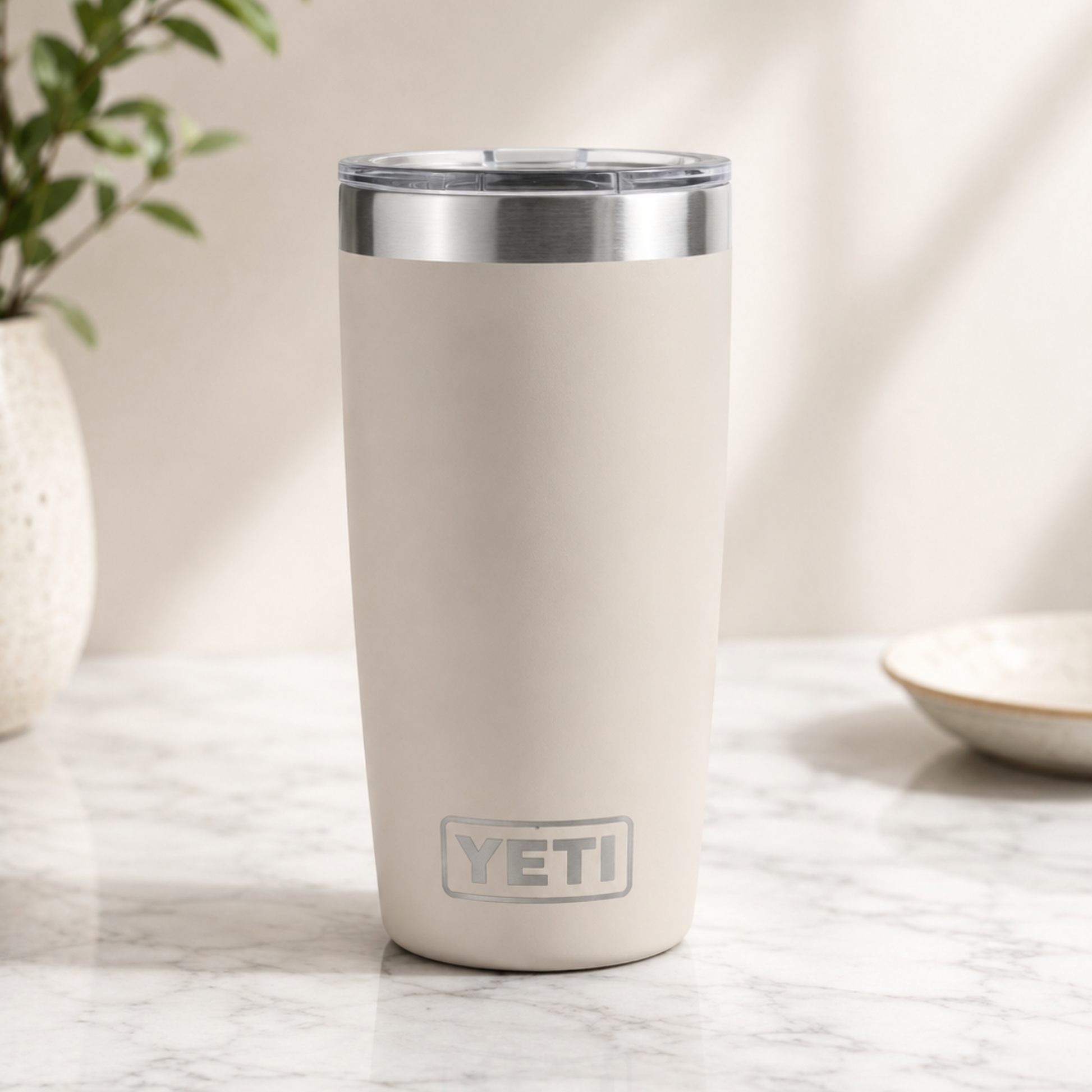 White YETI tumbler on a marble surface with a neutral background