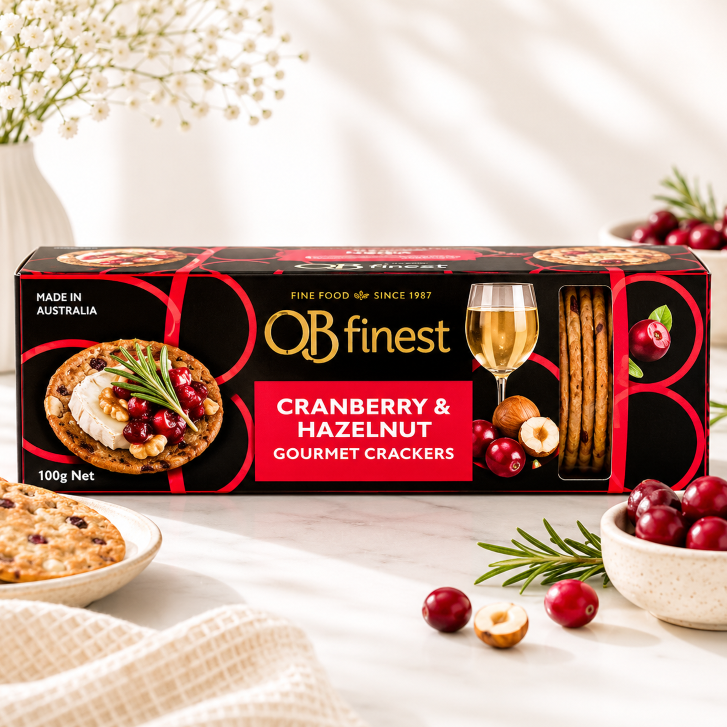 Box of Cranberry & Hazelnut Gourmet Crackers with crackers and cranberries on a table.