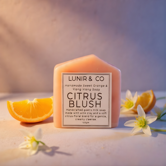 LUNIR & CO Citrus Blush soap with orange slices and flowers on a soft background