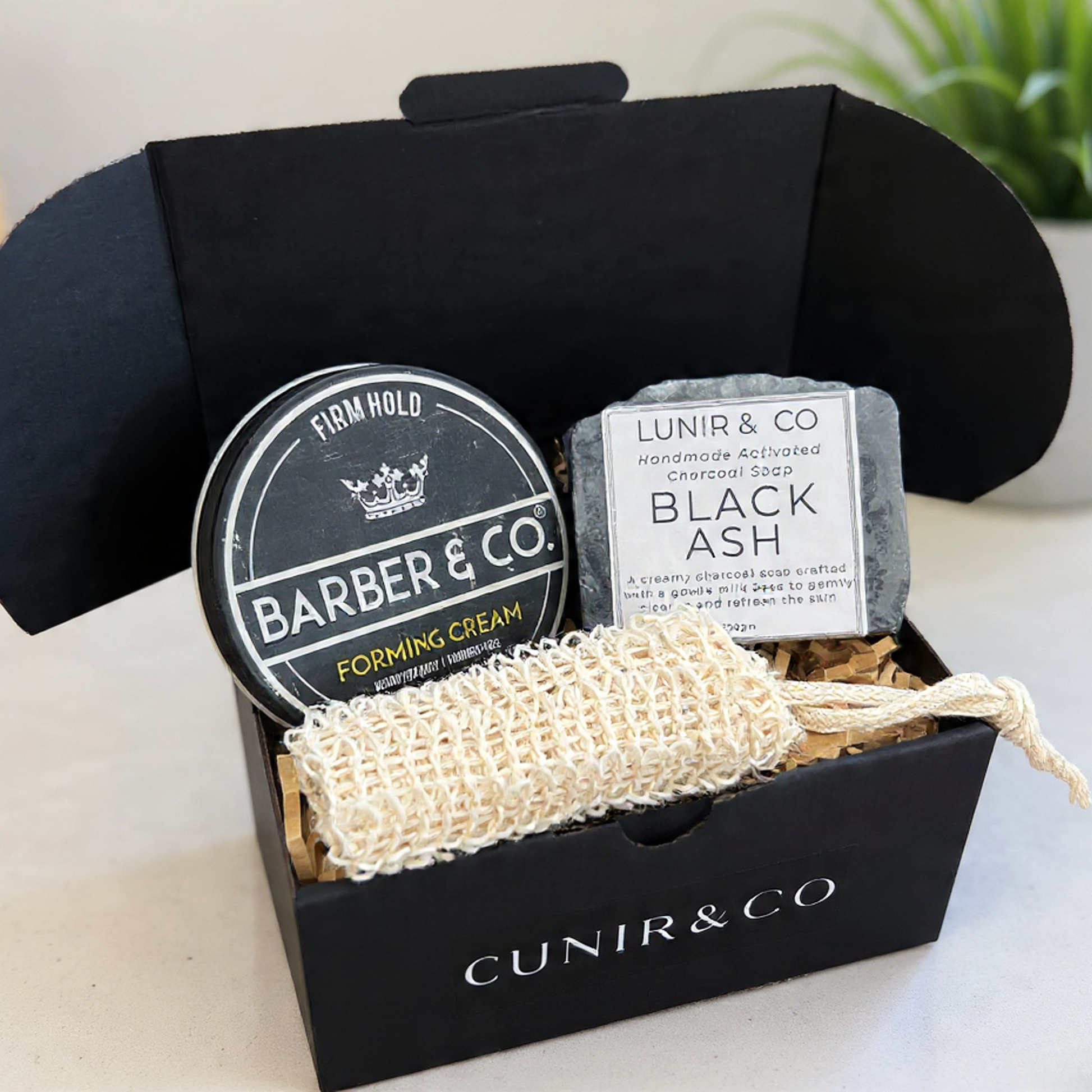 Barber & Co. grooming kit with forming cream, black ash soap, and a scrubber in a black box.