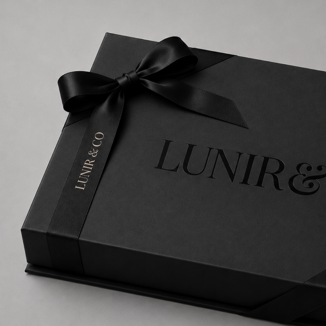 Black gift box with a bow and 'LUNIR & CO' branding on a light gray background