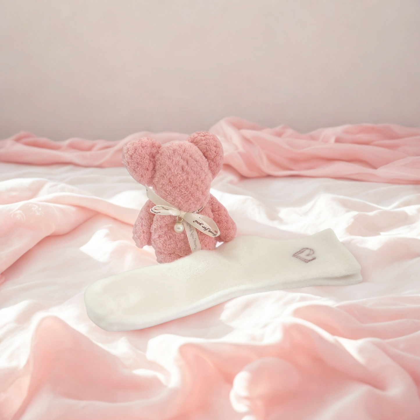 Jar of 'Cloud Mitt' scrub by Lunir & Co on a light surface with a vase of dried flowers in the background.